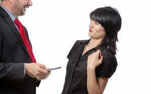 A man discussing the challenges of life with crooked teeth, considering a smile makeover and braces, with a woman in a business suit.